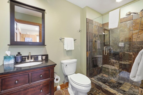 A bathroom with a sink, toilet, and a glass-enclosed shower area. - Ski In/Out| Combined Upper and Lower Unit 780/781 | 5 Bedroom | Gas Fireplace (Boyne Fallss)