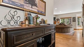 A living room with a dark wooden cabinet, a glass cabinet, and a brown sofa. - Doc's Place (Leadville)