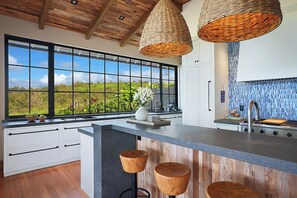 Enjoy casual dining and ample workspace in this kitchen with a large island and sink.