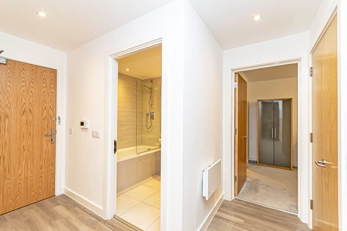 Bathtub, hair dryer, towels, shampoo