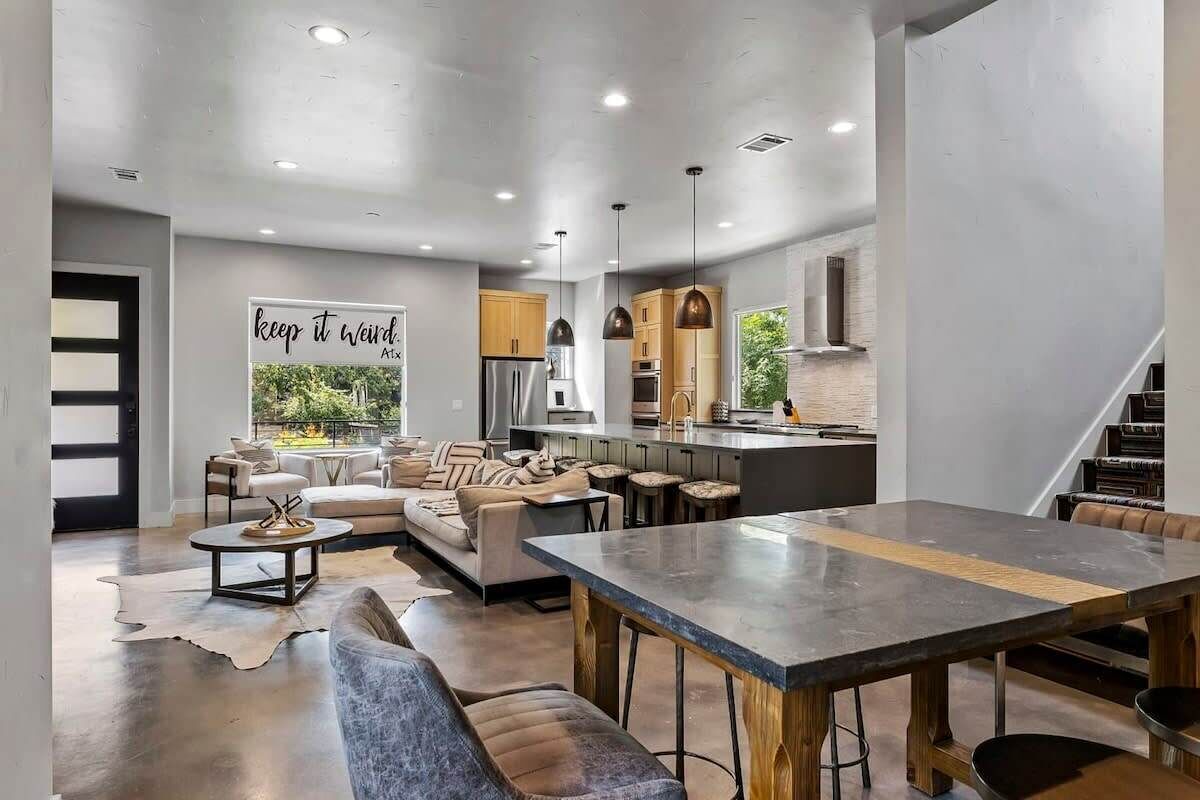 A modern interior with a dining area, kitchen, and seating space.