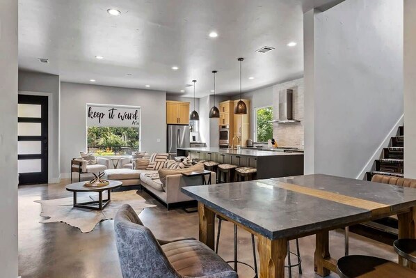 A modern interior with a dining area, kitchen, and seating space.