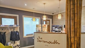 A reception area with a curved counter, wooden flooring, and a large window. - 3 bedroom accommodation in Dartmouth (Dartmouth)