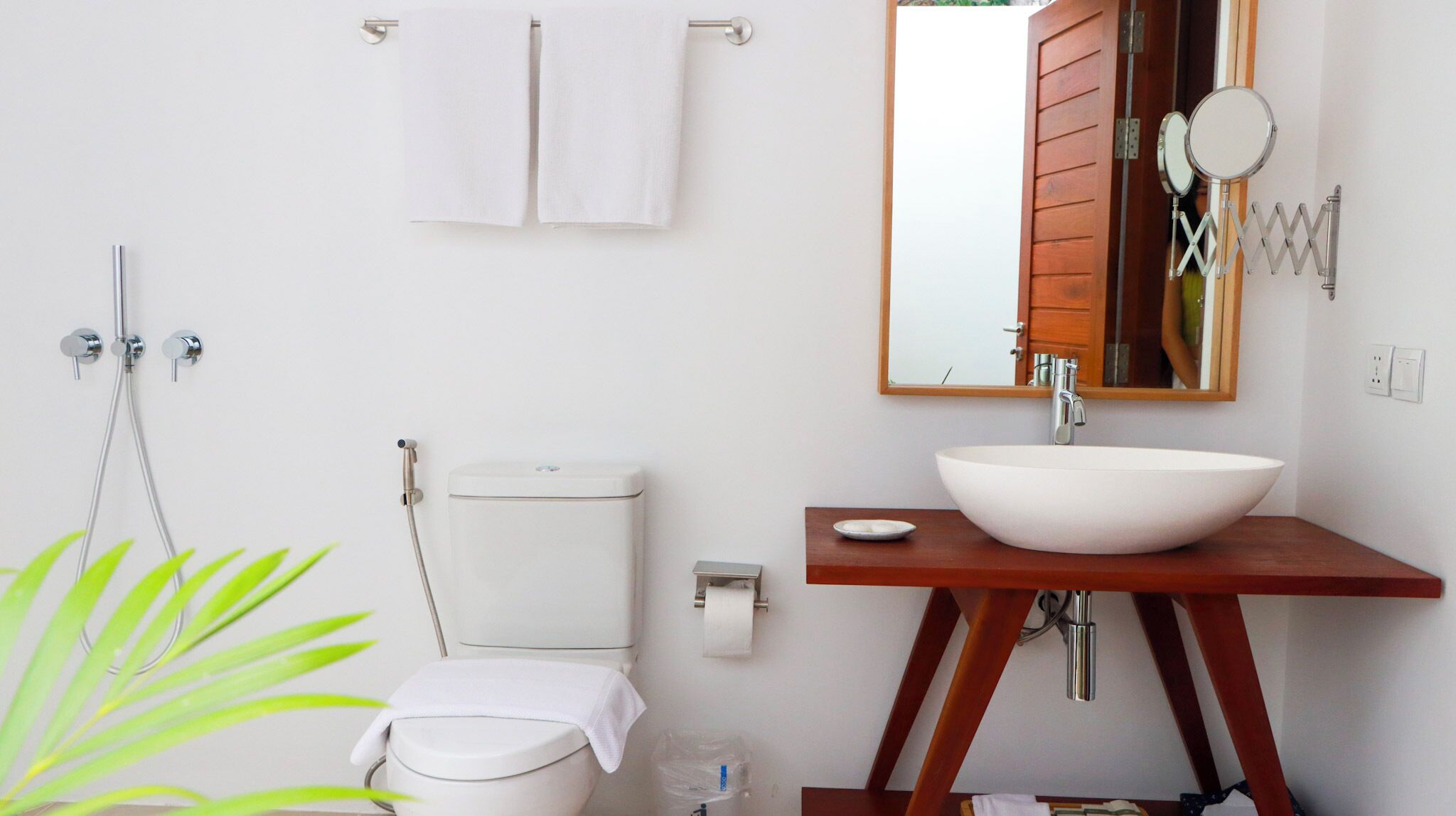 A bathroom with a toilet, bidet, and sink.