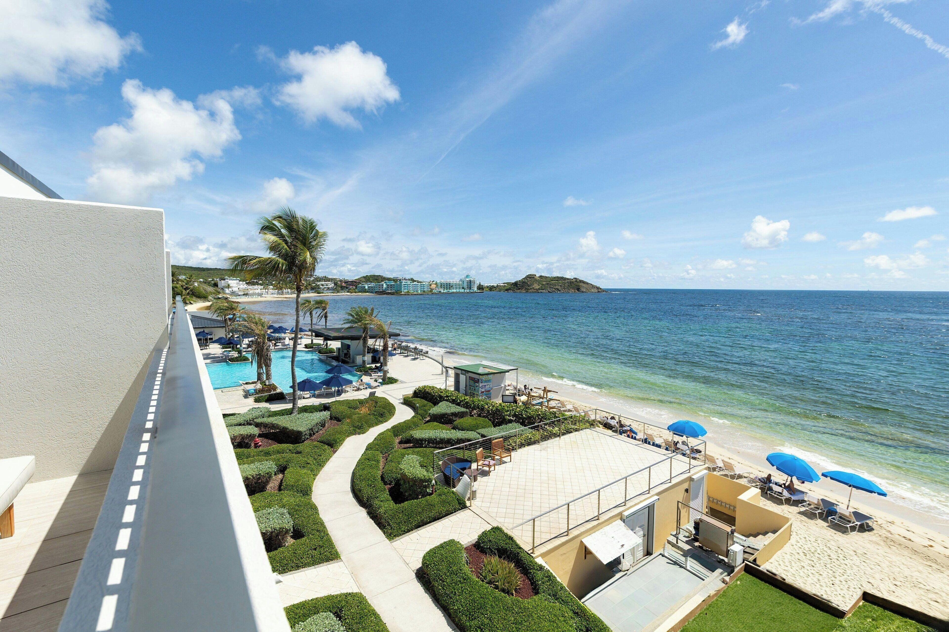 A resort with a pool, beach, and ocean view.
