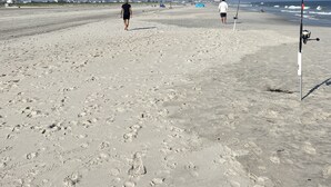A beach with footprints, fishing rods, and a clear sky. - Charming Family Friendly Townhome Walk to Beach, Near AC Fun, Pet Friendly (Brigantine)