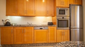 Enjoy cooking in this well-equipped kitchen with a dishwasher, microwave, and refrigerator.