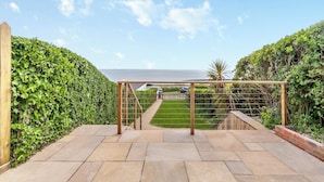 A paved pathway leading to a wooden pergola with a view of the sea. - Stunning views of the English Channel and Brighton Marina. (Brighton)