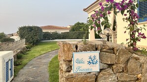 A stone wall with a sign reading "Villa Francesca."