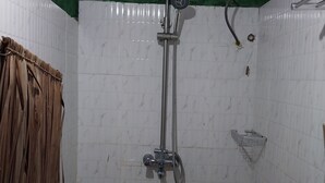A shower with a handheld showerhead, a wall-mounted faucet, and a shower control panel. - Green Garden Guest House  (Arusha)