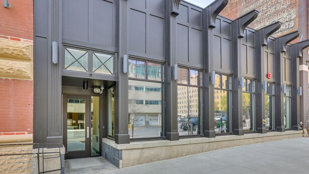 A modern building with large windows and a brick facade.