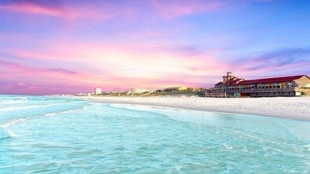 A beachfront hotel with a pier, ocean view, and a sunset sky. - August Dates Still Available! 5BR Luxury Home, Pool & Golf Cart • 3 Min to Beach (Miramar Beach)