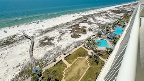 An aerial view of a beach resort with a swimming pool, a sandy beach, and a boardwalk. - Beach Club B1701 | Beachfront | Corner | Resort | Arcade | Pools | Hot Tubs (Gulf Shores)