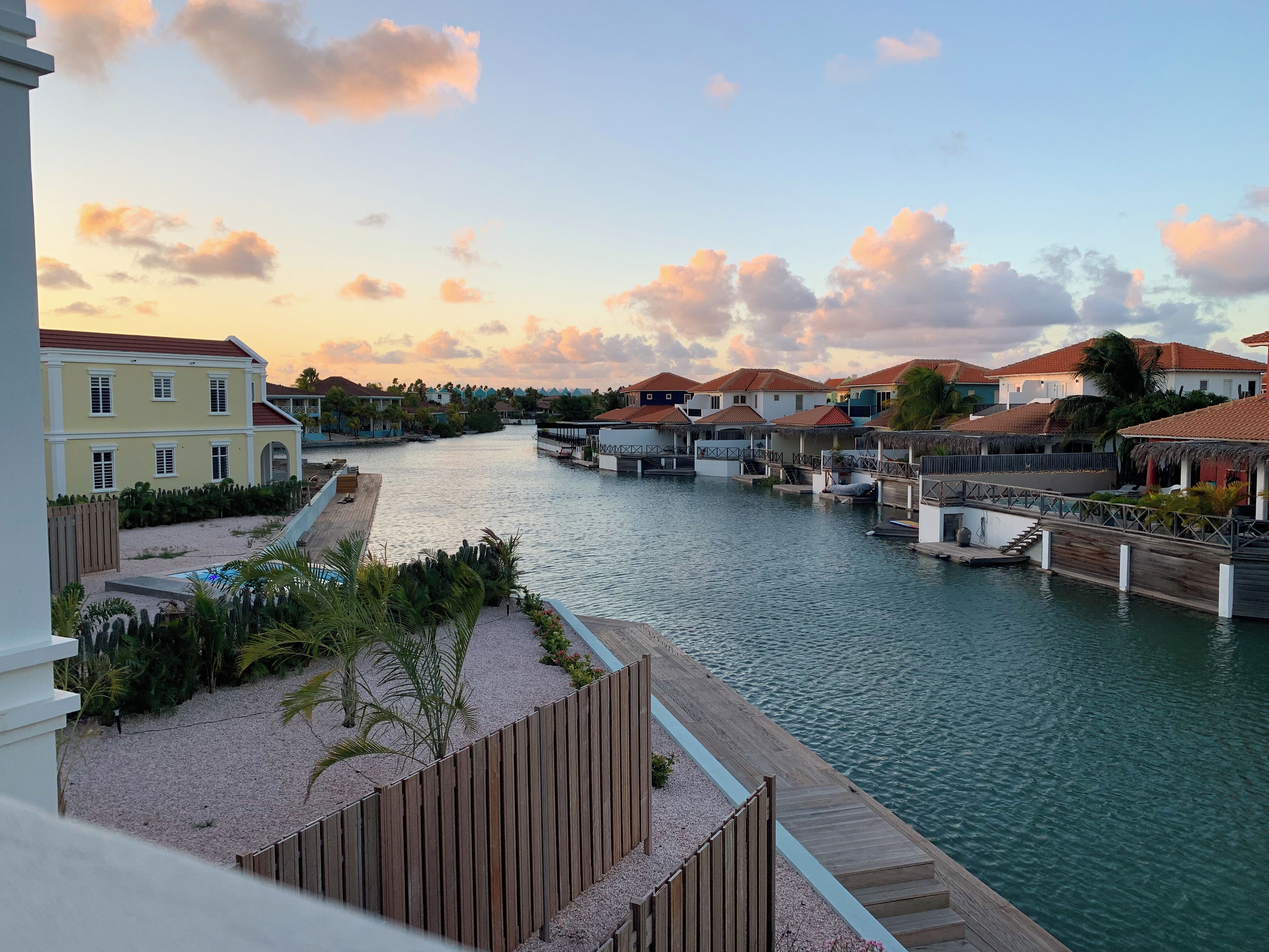 A waterfront property with multiple overwater bungalows connected by walkways.