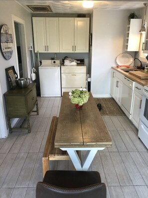Enjoy meals and work sessions at the central island table in this well-equipped kitchen.