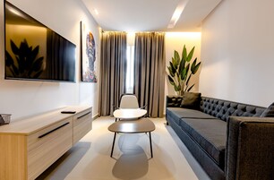 Luxury Suite | Living area | 38-inch plasma TV with satellite channels, TV