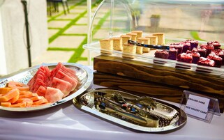 A dessert display with various cakes and fruits.