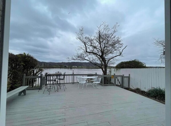 An outdoor deck with a wooden floor, metal chairs, and a bench. - Gallipolis along the river. No cleaning fee and no Taxes. (Gallipolis)
