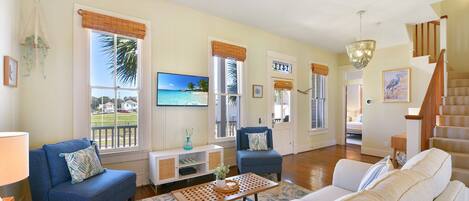 The living room has plenty of natural light and seating.