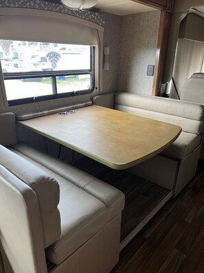 Enjoy meals in a cozy dining area with a table and comfortable seating.