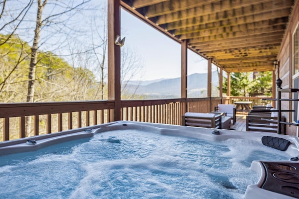 Soak in the hot tub while taking in breathtaking mountain views!