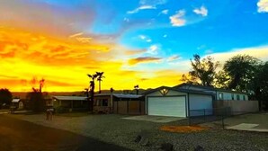 A residential area with houses and a clear sky during sunset.