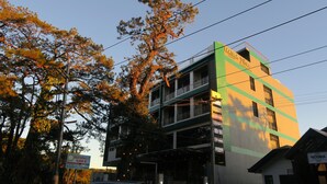 A multi-story building with balconies and signage for businesses. - Alvea Hotel Baguio  (Baguio)