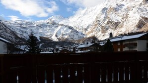 A mountainous landscape with snow-covered peaks and a residential area in the foreground. - Bergfreude 06 by Interhome (Saas-Fee)
