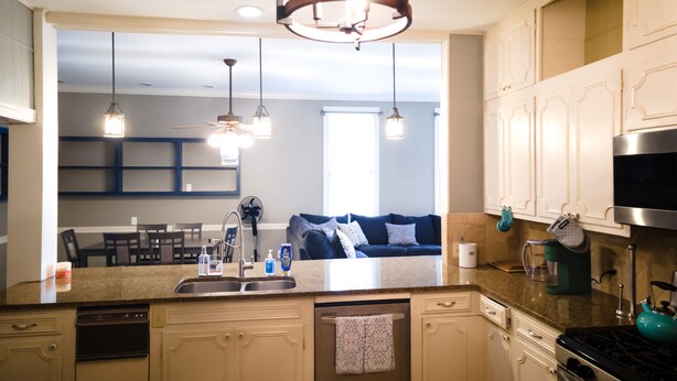 A modern kitchen with a central island, built-in appliances, and pendant lighting. - Arlington House (Natchez)