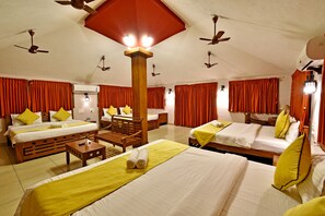 A hotel room with three beds, wooden furniture, and ceiling fans. - Poppys Olive De Villa (Vanur)