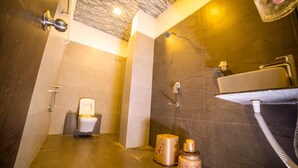 A bathroom with a toilet, shower, and sink. - Hotel KV Pride (Mehekar)