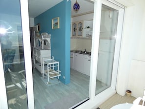 A kitchen with white cabinets, a sink, and a blue wall.
