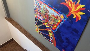 A staircase with a colorful mural on the wall. - HOTEL BELVEDERE (Canicatti)