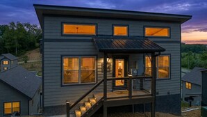 A two-story house with a covered porch and a staircase leading to the entrance. - Great Location/Close to Dollywood/HotTub/Arcade/Mountain View/Dog Friendly (Sevierville)