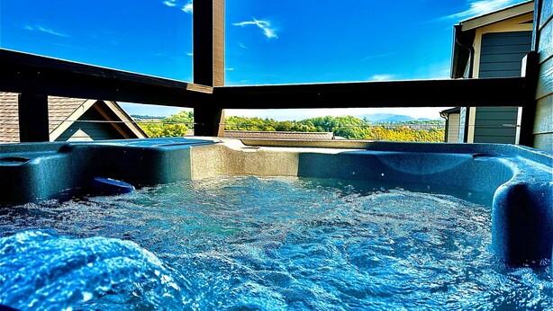 A hot tub with a clear view of the sky and greenery in the background. - Great Location/Close to Dollywood/HotTub/Arcade/Mountain View/Dog Friendly (Sevierville)