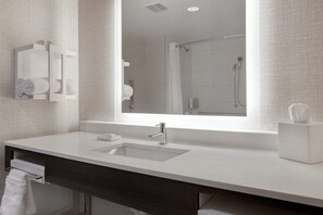 A modern bathroom with a large mirror, a sink, and a shower. - Hampton Inn Chicago Orland Park (Orland Park)