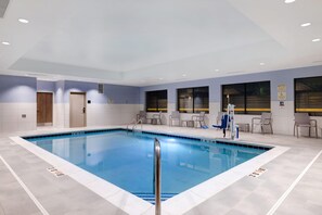 A swimming pool with a lifeguard stand, lounge chairs, and a door. - Hampton Inn Chicago Orland Park (Orland Park)