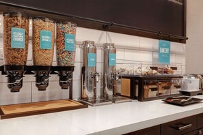 A breakfast bar with various cereal options and a bakery section. - Hampton Inn Chicago Orland Park (Orland Park)
