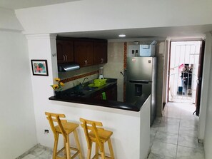 Fridge, coffee/tea maker, blender, cookware/dishes/utensils