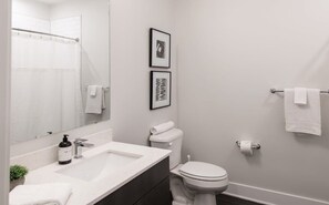 Bathtub, hair dryer, towels, shampoo