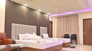 A modern hotel room with a large bed, a desk, and a chair. - Moon Star Beach Resort (Kanthi)