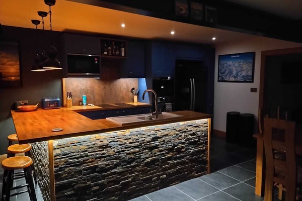 Includes large fridge/freezer with ice dispenser, bar stools, coffee machine