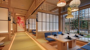 A traditional Japanese restaurant with tatami mat flooring, wooden furniture, and paper lanterns. - Wyndham Garden Gaozhou (Maoming)