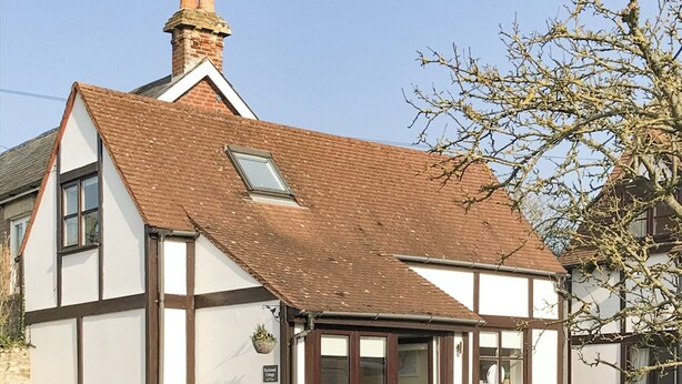 A traditional half-timbered cottage with a pitched roof, a small dormer window, and a brick chimney. - 1 bedroom accommodation in Wellow, near Yarmouth (Wellow, near Yarmouth)