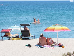 On the beach, sun loungers, beach towels