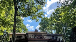 A two-story building with a covered deck and a staircase leading to the upper level. - Escape to Paradise: Your dream vacation awaits in our stunning lakefront rental! (Tomahawk)