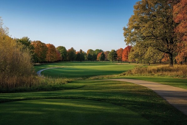 A golf course with a clear path, surrounded by trees with autumn foliage. - Cedar Lake Retreat with Private Beach + 8-Person Hot Tub (Nashua)