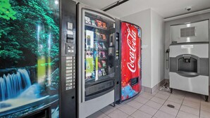 A vending machine area with a Coca-Cola branded machine and a Scotman branded machine. - Studio 6 Suites Escondido, CA (Escondido)
