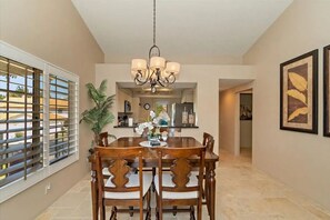 Enjoy meals in this spacious dining area with a large table and six comfortable chairs.