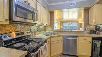 Deluxe Condo | Private kitchen | Full-sized fridge, microwave, oven, stovetop